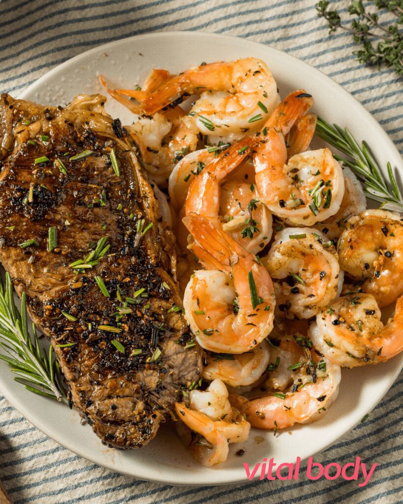 Display of steak and prawns on a plate.