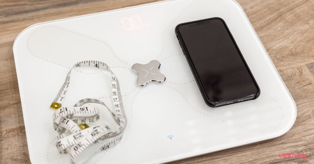 Smart body composition scale with a phone and a measuring tape on top