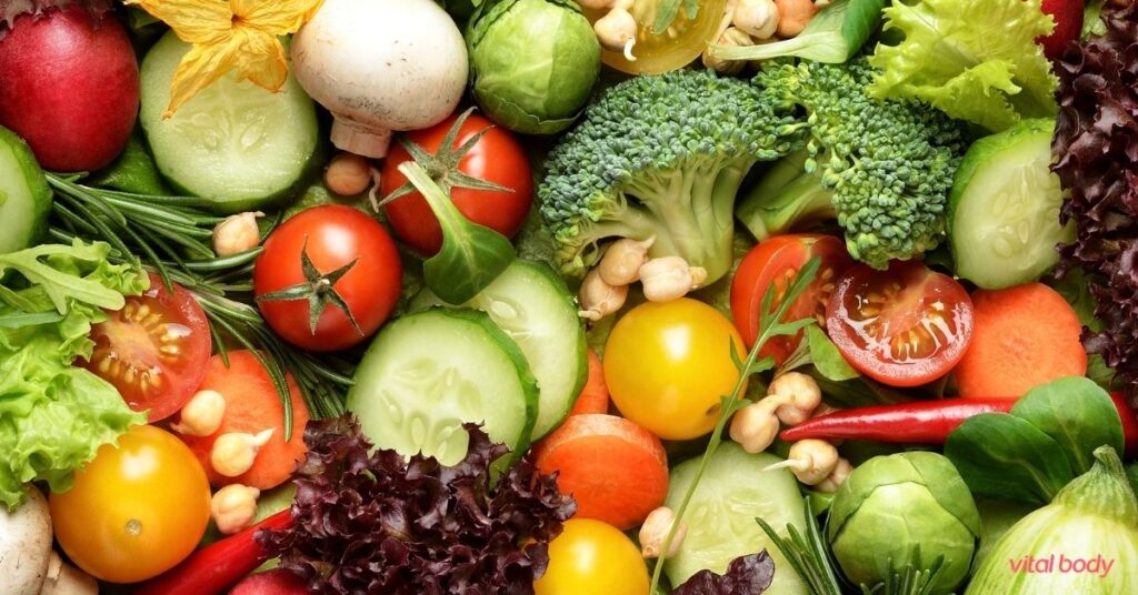 Fresh vegetables close up, including broccoli, cucumber, tomatoes, mushrooms, Brussels sprouts and lettuce