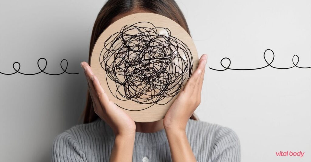 Woman holding a disc with a tangled line over her face, showing how many reasons can get knotted together when weight loss stalls